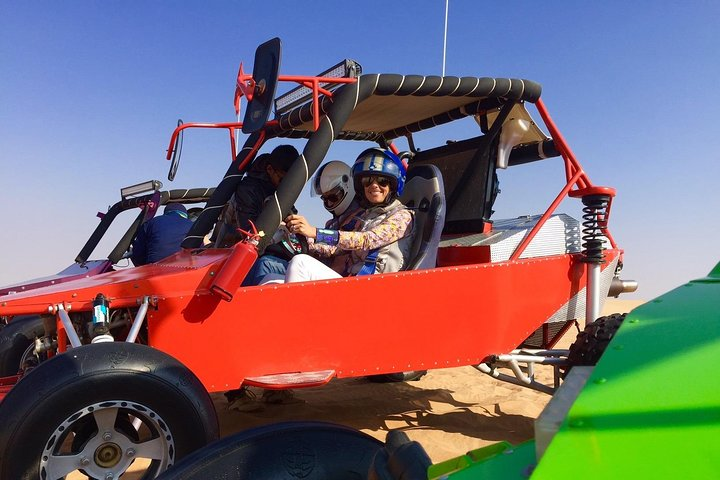 Experience the serene beauty of untouched desert landscapes as you navigate the golden sands in custom dune buggies searching for wild gazelles and embracing the thrill of adventure.